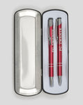 Two red FC Twente pens in an open silver metal tin with white lining