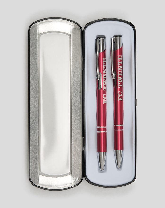 Two red FC Twente pens in an open silver metal tin with white lining