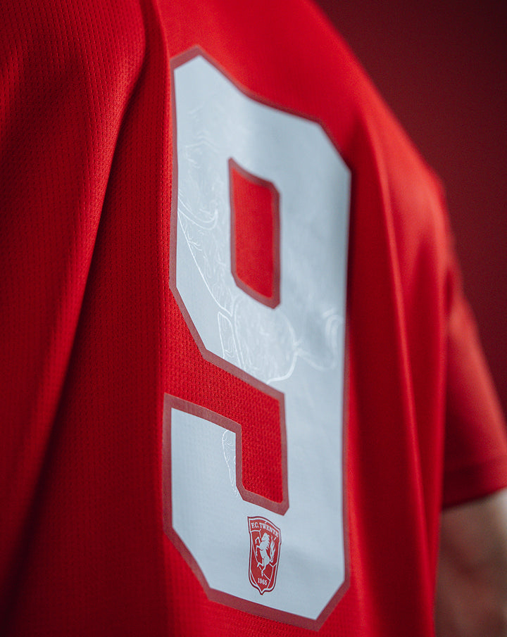Close-up of FC Twente home shirt 25/26 for men showing a large white number 9 on red fabric and club crest