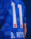Back view of blue FC Twente 25/26 away shirt with large white number 11 and two club crests.