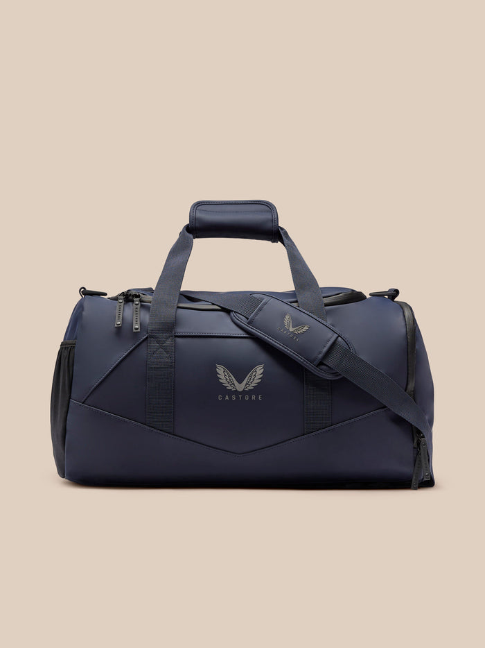 Core Holdall in midnight blue with padded carry handles and adjustable detachable strap.