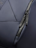 Detail of Core Holdall zipper with branded pulls on navy polyurethane exterior.