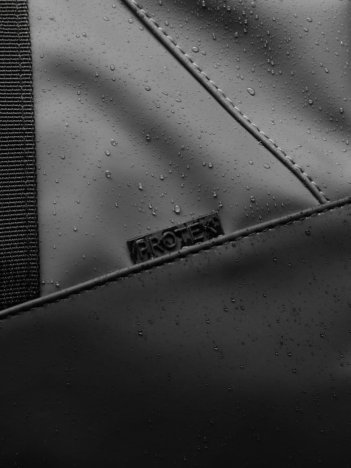 Close up of ProTek waterproof surface and stitching on the Core Holdall gunmetal bag