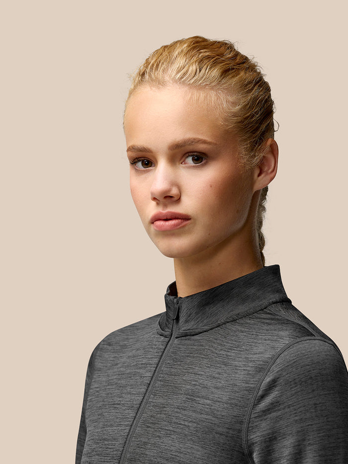 Close-up of Flow Training Fleece Half Zip Top in black, highlighting funnel collar and center front half zip.