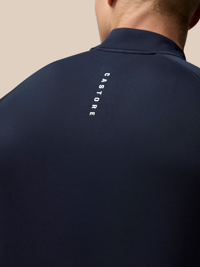 Back view of navy Adapt Training top with vertical Castore logo along the upper back