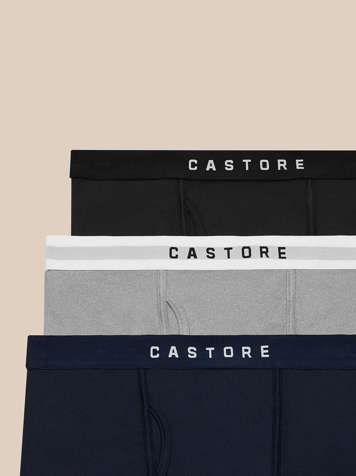 Three Castore boxer briefs in black grey and navy with branded waistbands stacked.