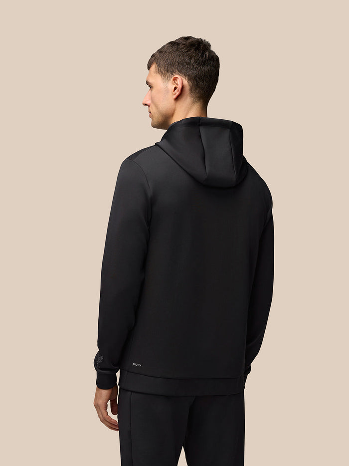 Back view of a man wearing a black Flex Hoodie with the hood resting on his shoulders.