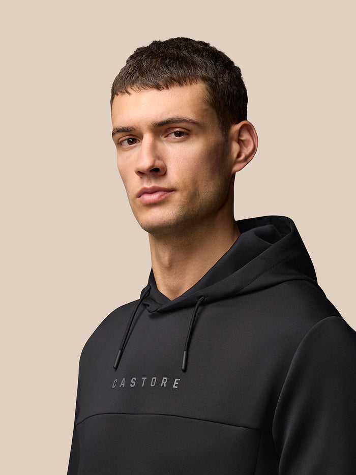 Portrait of a man in a black hoodie with CASTORE lettering on the chest.