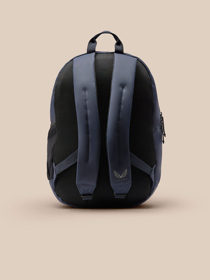 Back view of Active Backpack Navy with padded shoulder straps, mesh back panel, top carry handle, and reflective Castore logo.