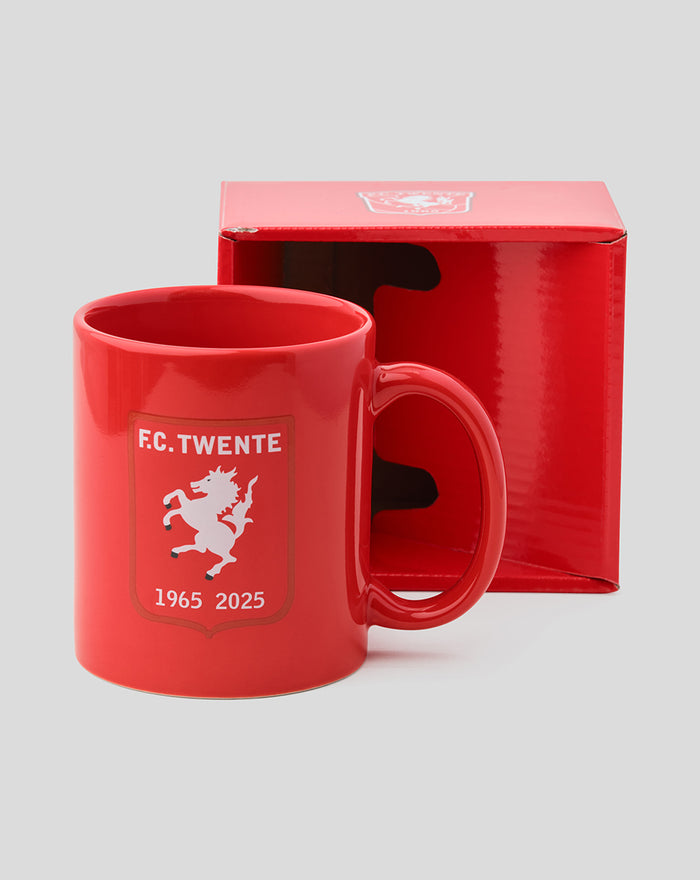 Red FC Twente jubileum mug with white horse crest on the front, shown beside a red gift box.