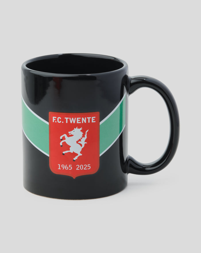 Side view of the black FC Twente Jubilee mug with crest on the front and a red box behind
