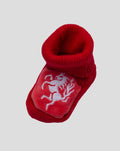 Red knitted baby bootie with turned cuff and FC Twente crest