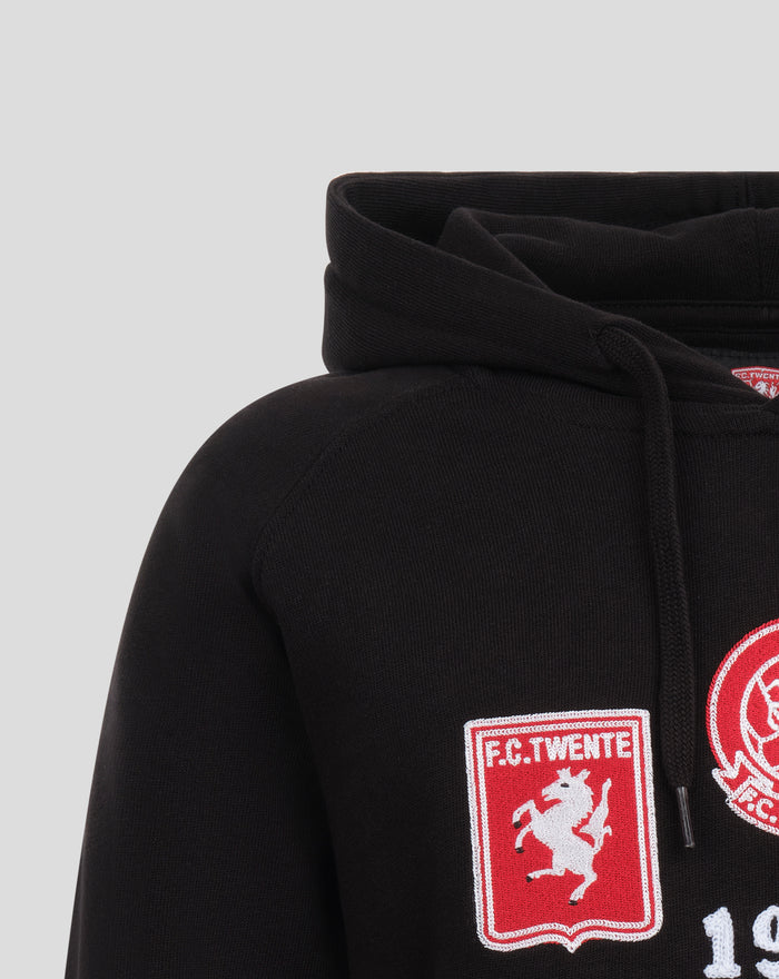 Close-up of a black FC Twente Copa Heritage Hoodie hood with drawstrings and a crest patch visible