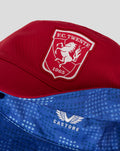 Close-up of red FC Twente bucket hat showing embroidered crest patch on the front with 1965