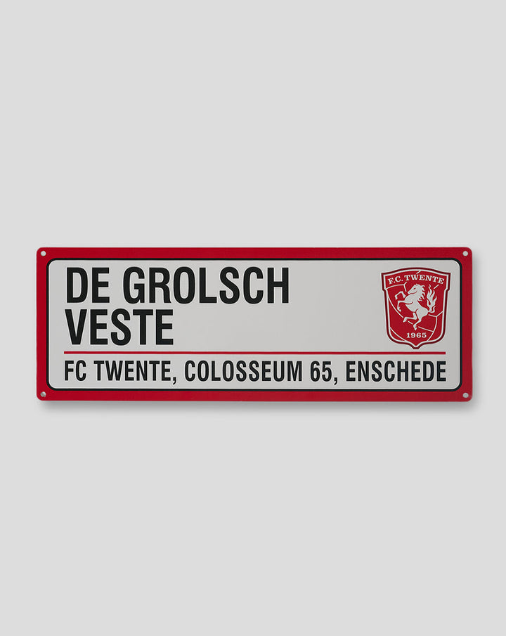 Red metal FC Twente street sign with bold text and crest
