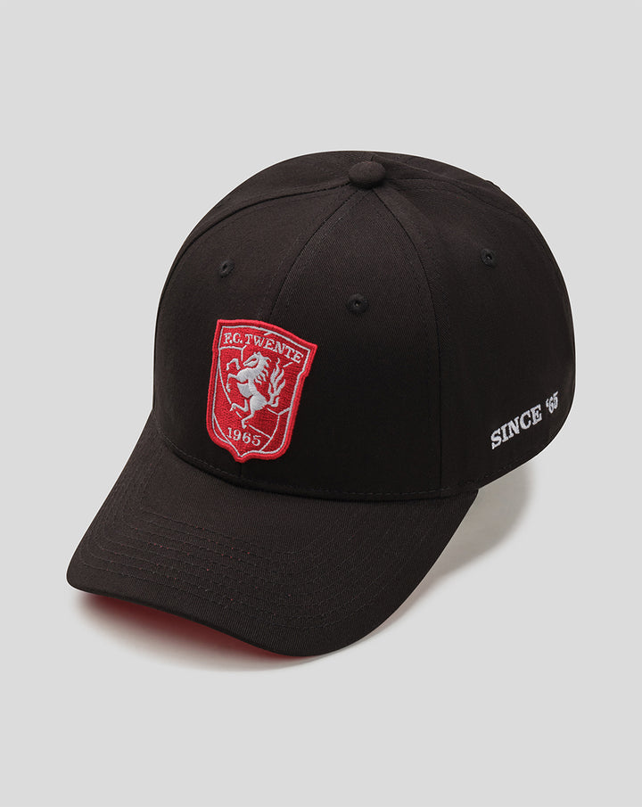 Angled view of black FC Twente cap with red crest on the front and white Since 1965 text on the side.