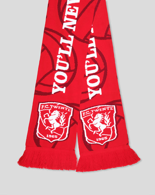 Close-up of red FC Twente scarf fringe with white crests and YOU'LL NEVER WALK ALONE text visible
