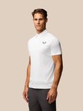Male model wearing a white Golf Pinnacle Pique Stripe Polo with subtle horizontal stripes and a small chest logo.