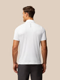 Back view of a man wearing a white Golf Pinnacle Pique Stripe Polo with Castore branding along the upper back