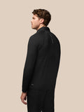 Back view of a man in a black Pinnacle hybrid golf jacket with a standing collar and CASTORE logo along the upper back
