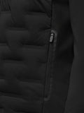 Close up of a zip pocket on the black Pinnacle hybrid quilted golf jacket showing quilting and a CASTORE zipper pull