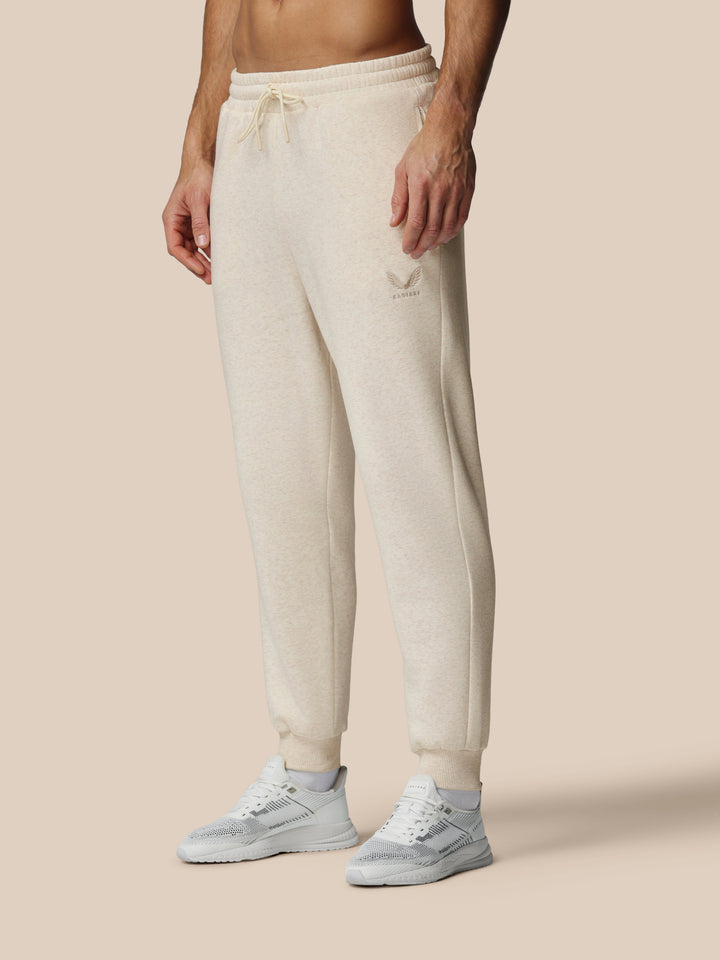 Beige oatmeal fleece joggers with Castore logo on left thigh and drawstring waist