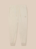Front view of beige fleece joggers with drawstring waist and ribbed cuffs, featuring an embroidered Castore logo on the left thigh.
