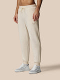 Beige oatmeal fleece joggers with Castore logo on left thigh and drawstring waist