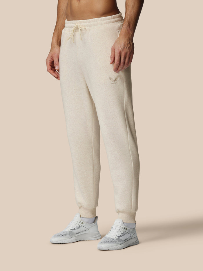 Beige oatmeal fleece joggers with Castore logo on left thigh and drawstring waist