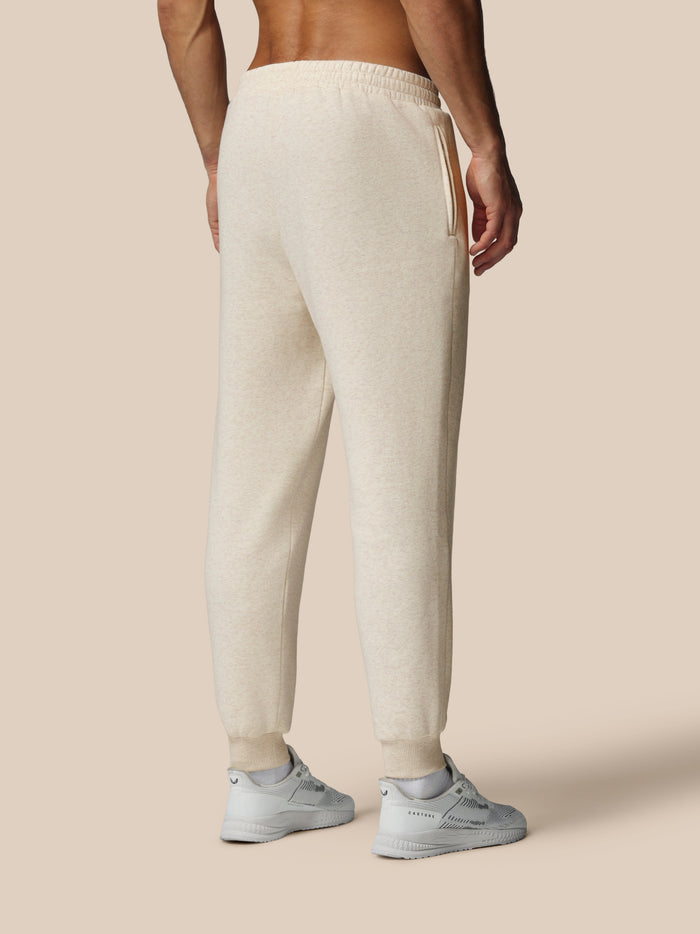 Back view of oatmeal fleece joggers with zip side pocket and ribbed cuffs