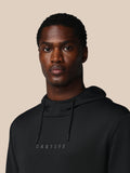 Close-up van man in zwarte Flex hoodie met trekkoorden en Castore logo op borst