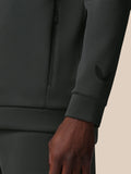Close-up of the gunmetal sweatshirt showing a vertical quarter zip and Castore logo on the sleeve
