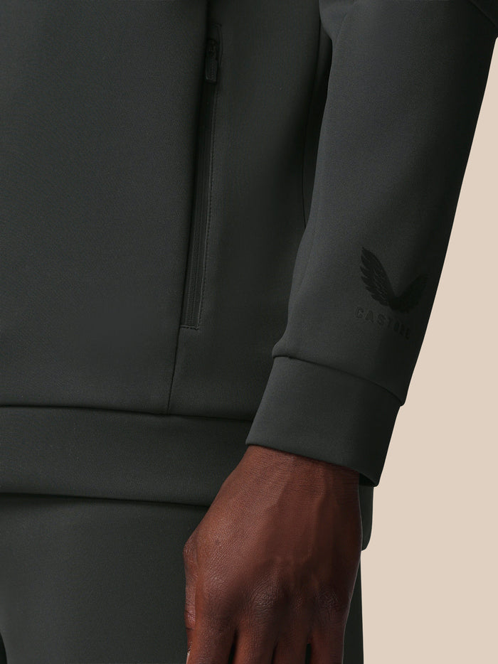 Close-up of the gunmetal sweatshirt showing a vertical quarter zip and Castore logo on the sleeve