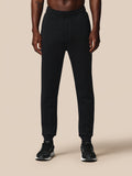 Full length shot of black Heren Flex Joggers worn by a model with sneakers.