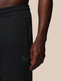 Close-up of black Heren Flex Joggers showing elastic waistband, side zip pocket and Castore logo on the thigh