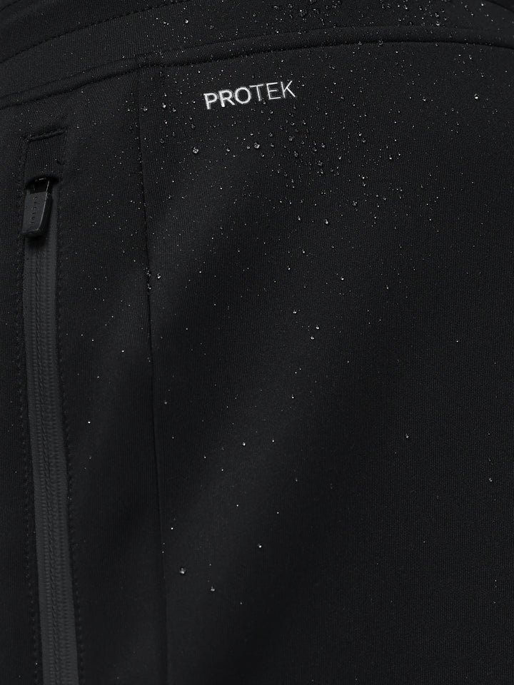 Close-up of black fabric with water droplets and ProTek branding highlighting rain resistance and zipper detail