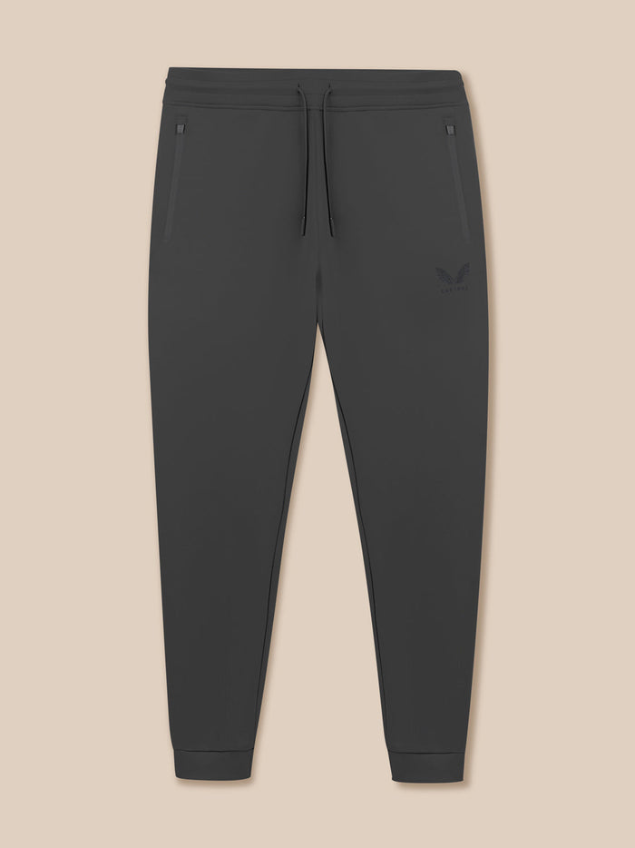 Front view of Gunmetal Heren Flex Joggers with elastic waistband drawcord and zip pockets and Castore logo on left thigh.