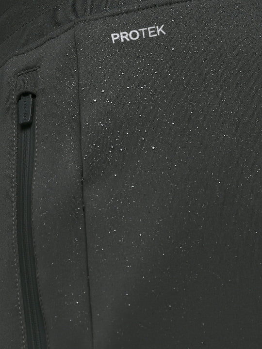 Close up of ProTek label on Gunmetal Heren Flex Joggers fabric showing waterproof detail and a zip pocket.