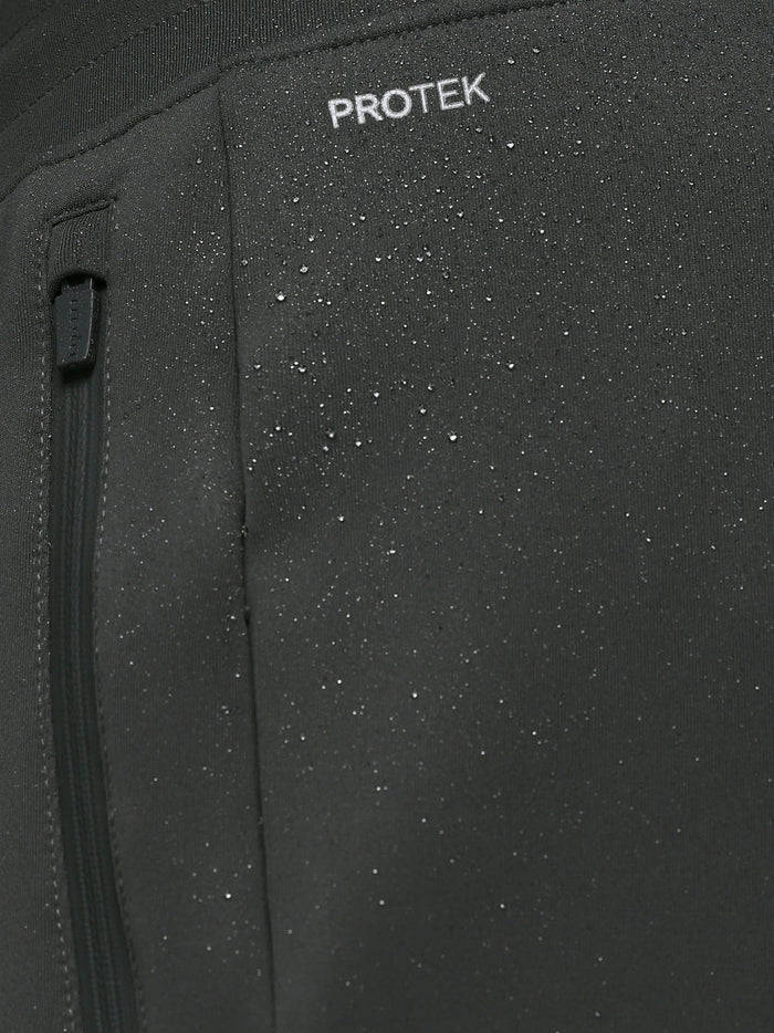 Close up of ProTek label on Gunmetal Heren Flex Joggers fabric showing waterproof detail and a zip pocket.