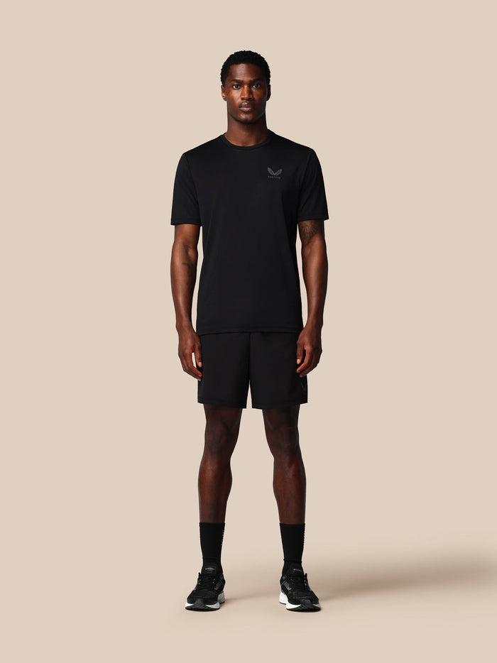 Full-body front view of a male model in black Adapt Training Shorts and matching top