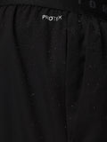 Close up of black shorts waistband showing CASTORE branding and water droplets on fabric.
