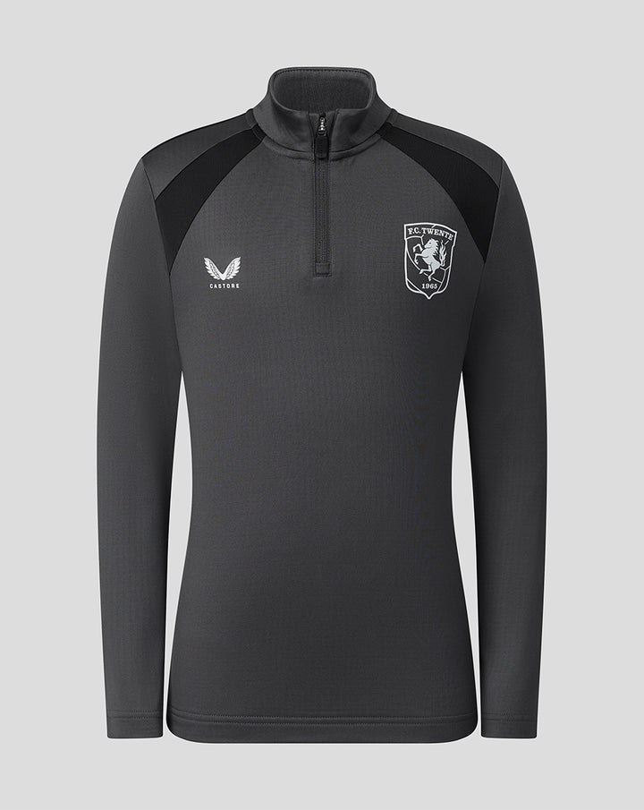 Front view of junior gunmetal FC Twente training midlayer top with club crest on left chest and Castore logo on right.