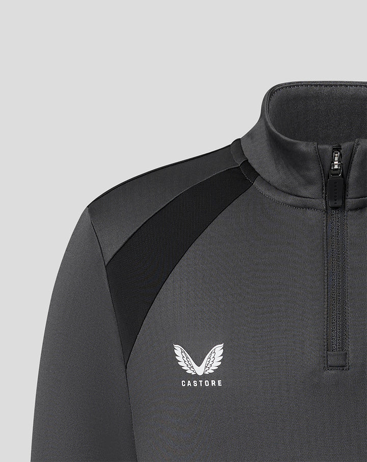Close up of a gunmetal FC Twente junior training midlayer with a high funnel neck front zip and black shoulder panels.