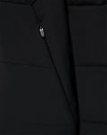Close-up of black padded FC Twente training jacket showing front zipper and quilted panels