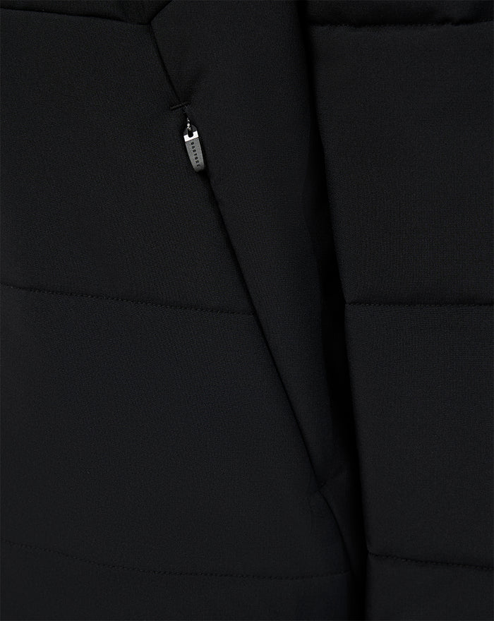 Close-up of black padded FC Twente training jacket showing front zipper and quilted panels