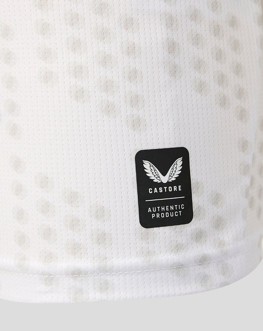 Black Castore Authentic Product badge on white perforated fabric of FC Twente third shirt.