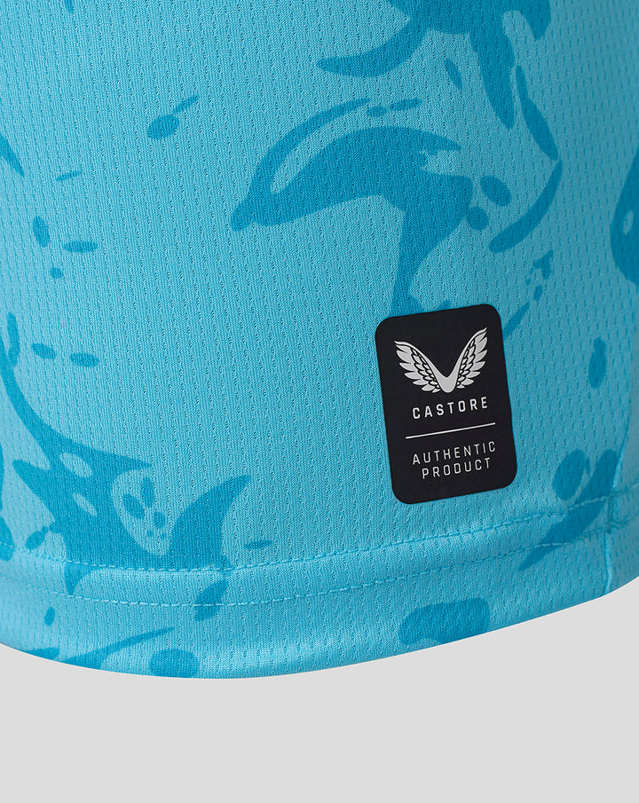Close-up of turquoise FC Twente keeper shirt fabric with Castore Authentic Product patch.