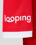 Lower front of FC Twente home shirt with red fabric and white hem and bold sponsor lettering visible across the chest area