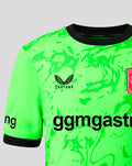 Neon green FC Twente keeper jersey with black collar and bold abstract print, Castore logo and club crest visible