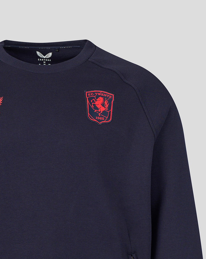 Front view of navy FC Twente Travel fleece sweater with red crest on the chest and wing logo